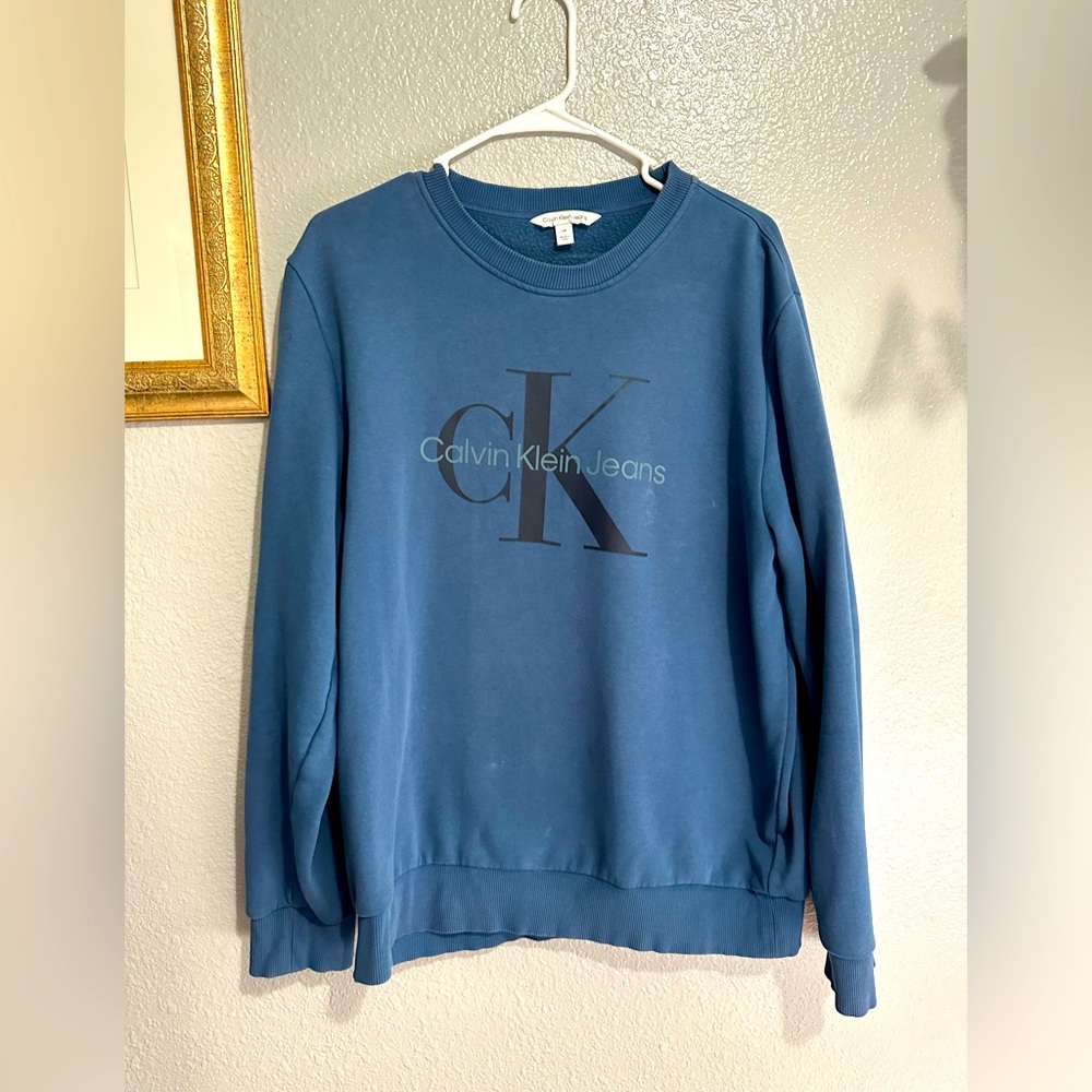 I am selling a Men’s Calvin Klein Jeans Blue Crewneck. Size large.